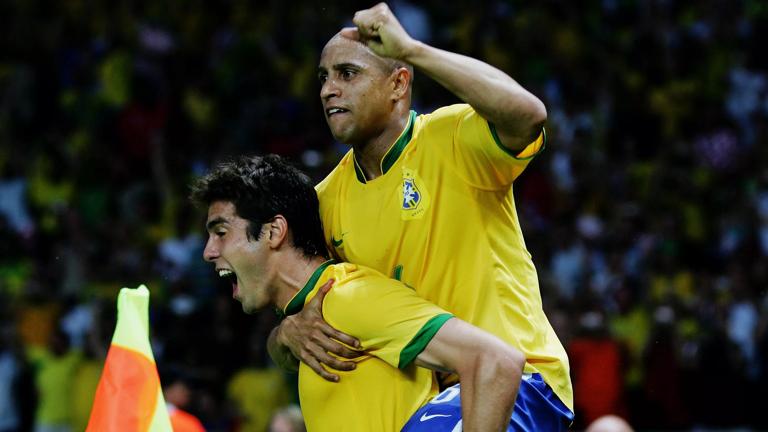 BERLIN - JUNE 13: Kaka of Brazil celebrates scoring the opening goal with team mate Roberto Carlos (R) during the FIFA World Cup Germany 2006 Group F match between Brazil and Croatia played at the Olympic Stadium on June 13, 2006 in Berlin, Germany. (Photo by Alex Livesey/Getty Images)