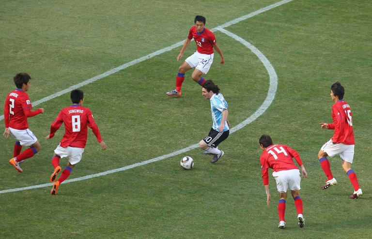 JOHANNESBURG, SOUTH AFRICA - JUNE 17: Lionel Messi of Argentina takes on the South Korea defence during the 2010 FIFA World Cup South Africa Group B match between Argentina and South Korea at Soccer City Stadium on June 17, 2010 in Johannesburg, South Africa. (Photo by Cameron Spencer/Getty Images)