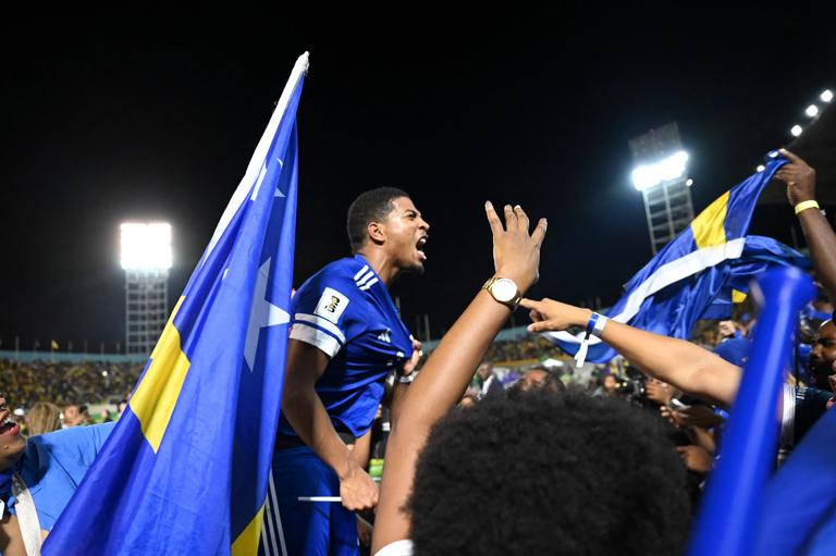 Curaçao players and fans celebrate World Cup 2026 qualification after a 0-0 draw with Jamaica at the National Stadium in Kingston, Jamaica on November 18, 2025. The tiny Caribbean nation of Curacao became the smallest country ever to qualify for the World Cup on November 18 as Haiti booked their return to the tournament for the first time in 52 years along with Panama.
A nerve-shredding finale to the CONCACAF qualifying campaign saw Curacao -- with a population of just 156,000 -- squeeze into next year's finals in the United States, Canada and Mexico with a 0-0 draw against Jamaica in Kingston. (Photo by Ricardo MAKYN / AFP) (Photo by RICARDO MAKYN/AFP via Getty Images)