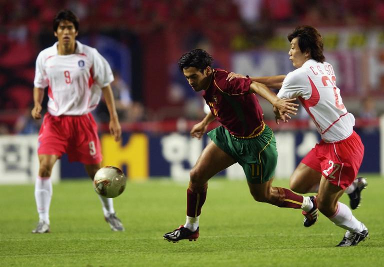 INCHEON - JUNE 14: Chong Gug Song of South Korea holds back Sergio Conceicao of Portugal during the FIFA World Cup Finals 2002 Group D match played at the Incheon Munhak Stadium, in Incheon, South Korea on June 14, 2002. South Korea won the match 1-0. DIGITAL IMAGE. (Photo by Clive Brunskill/Getty Images)